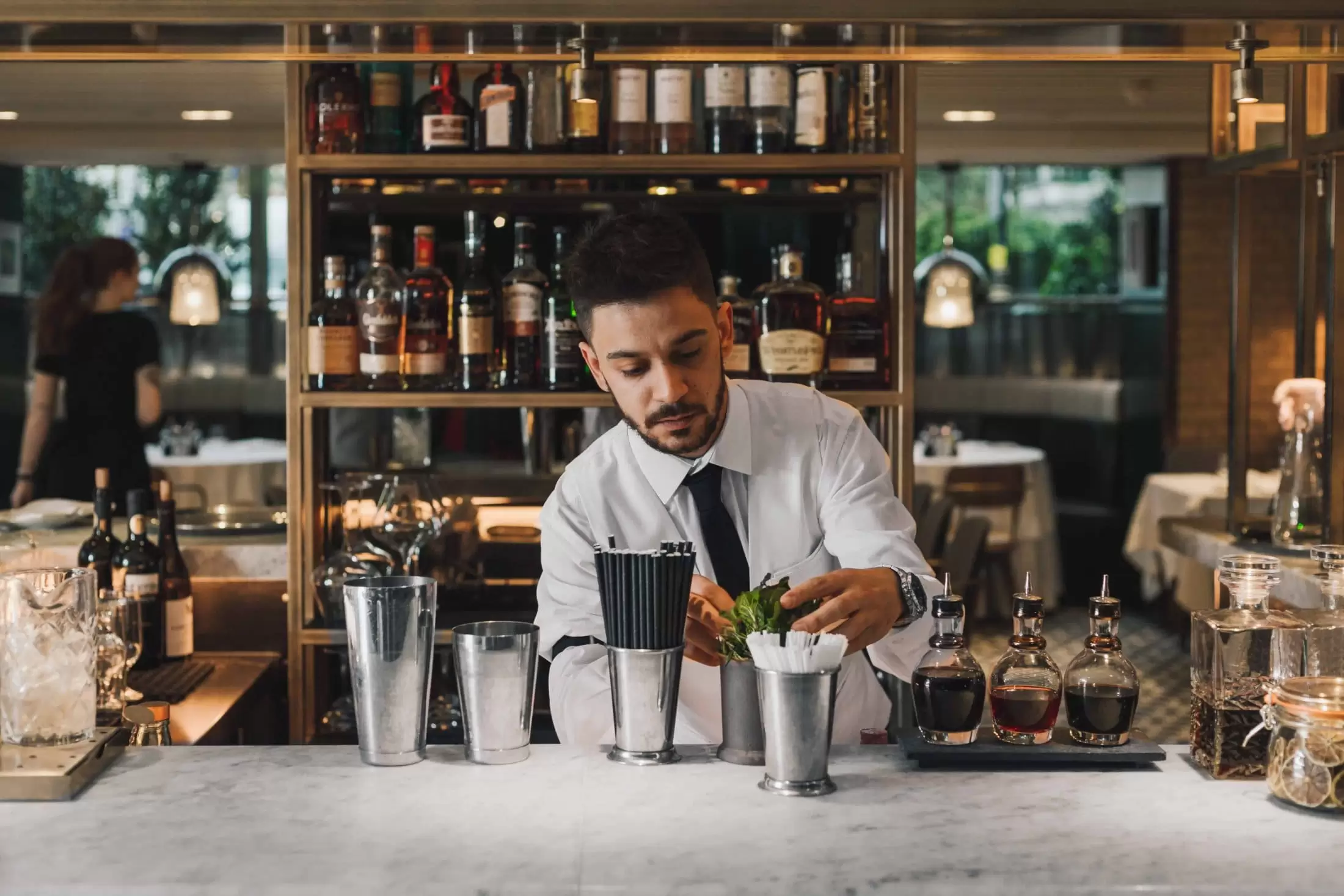 The Hari Bartender making a classic cocktail behind the bar