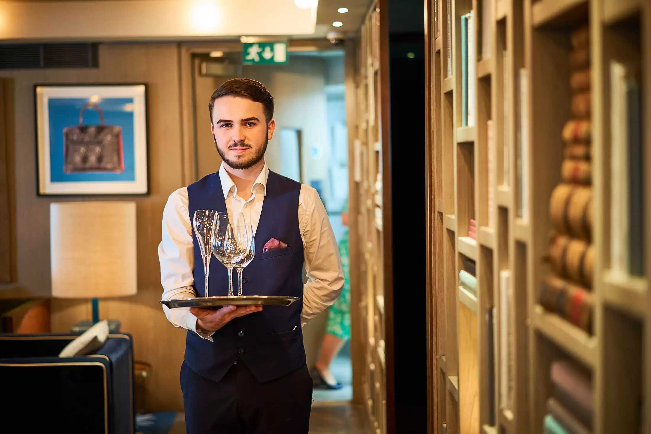 A Hari employee with a drinks tray in The Hari Bar
