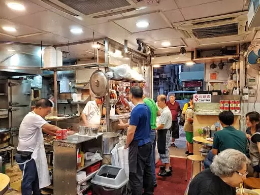 People standing at the counter inside Joy Hing