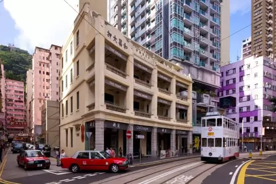 The exterior of The Pawn with a tram outside