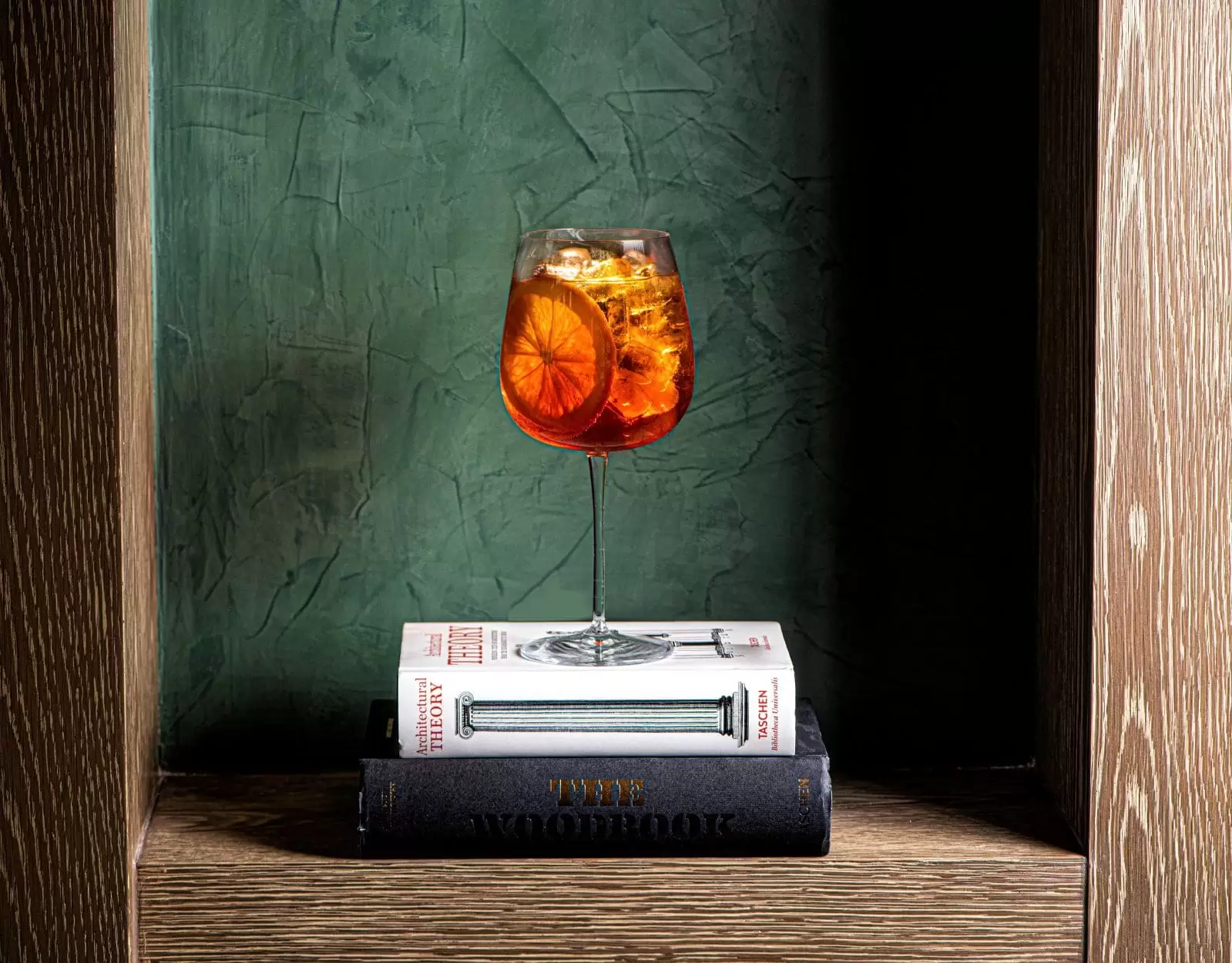 An Aperol Spritz on top of a book in the decor of Lucciola