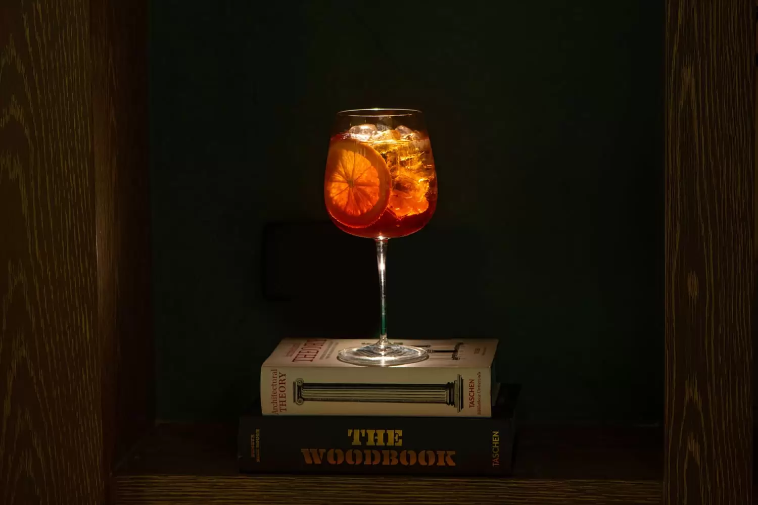 An Aperol Spritz on top of a book in the decor of Lucciola
