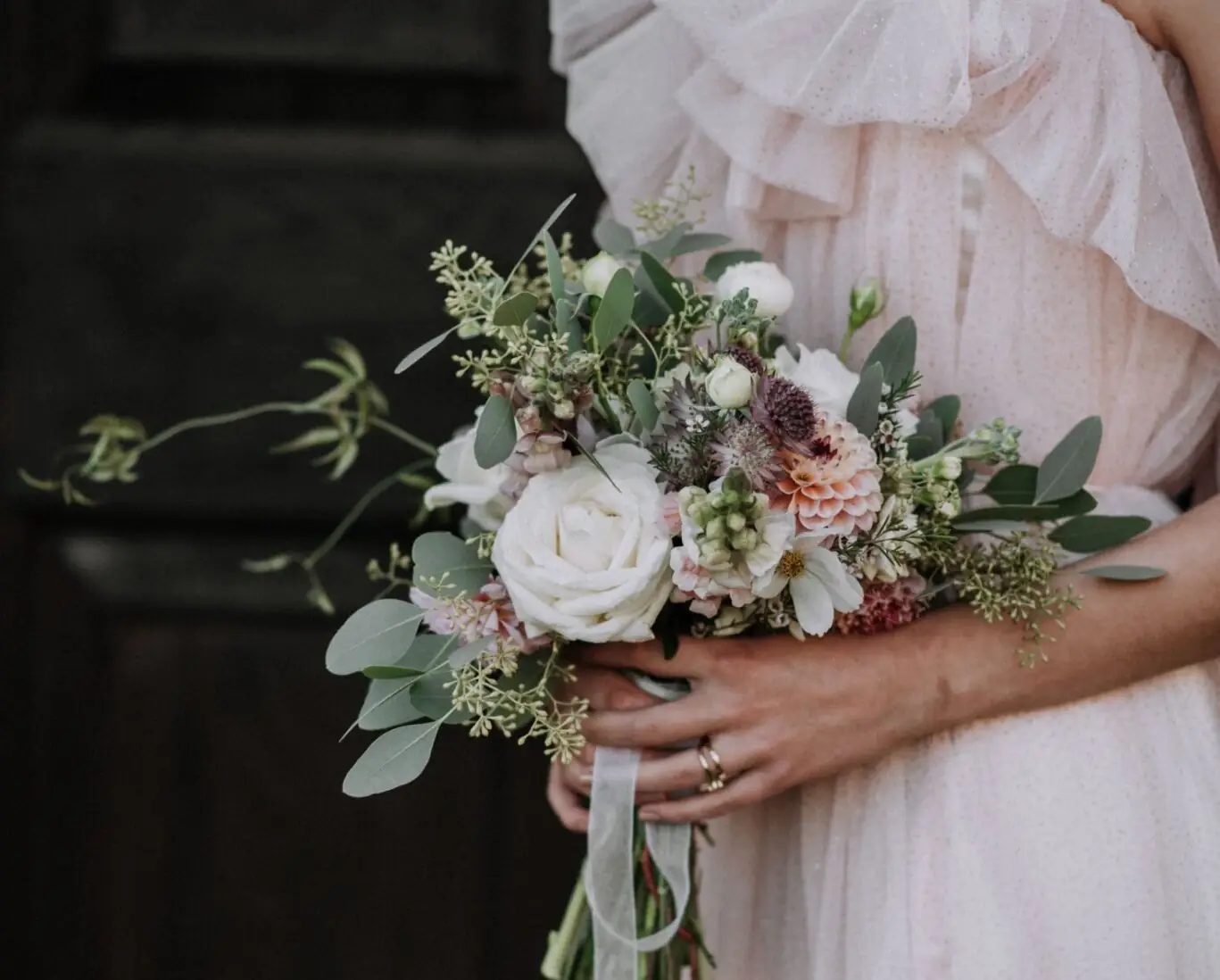 vertical-shot-bride-wearing-wedding-dress-holding-flower-bouquet (1)