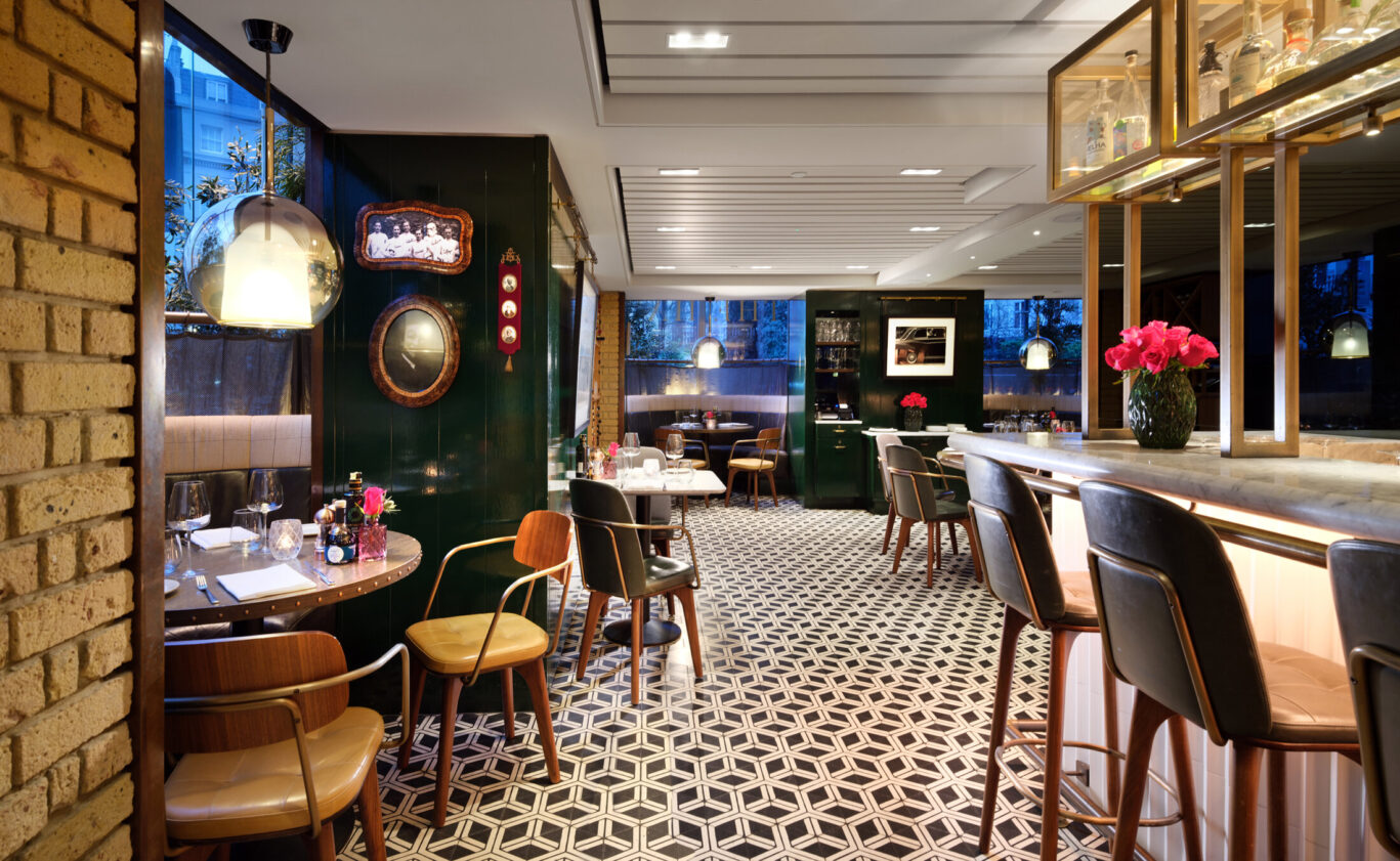 Interior of il Pampero Italian restaurant at The Hari, featuring warm lighting, elegant décor, and dining tables set for guests