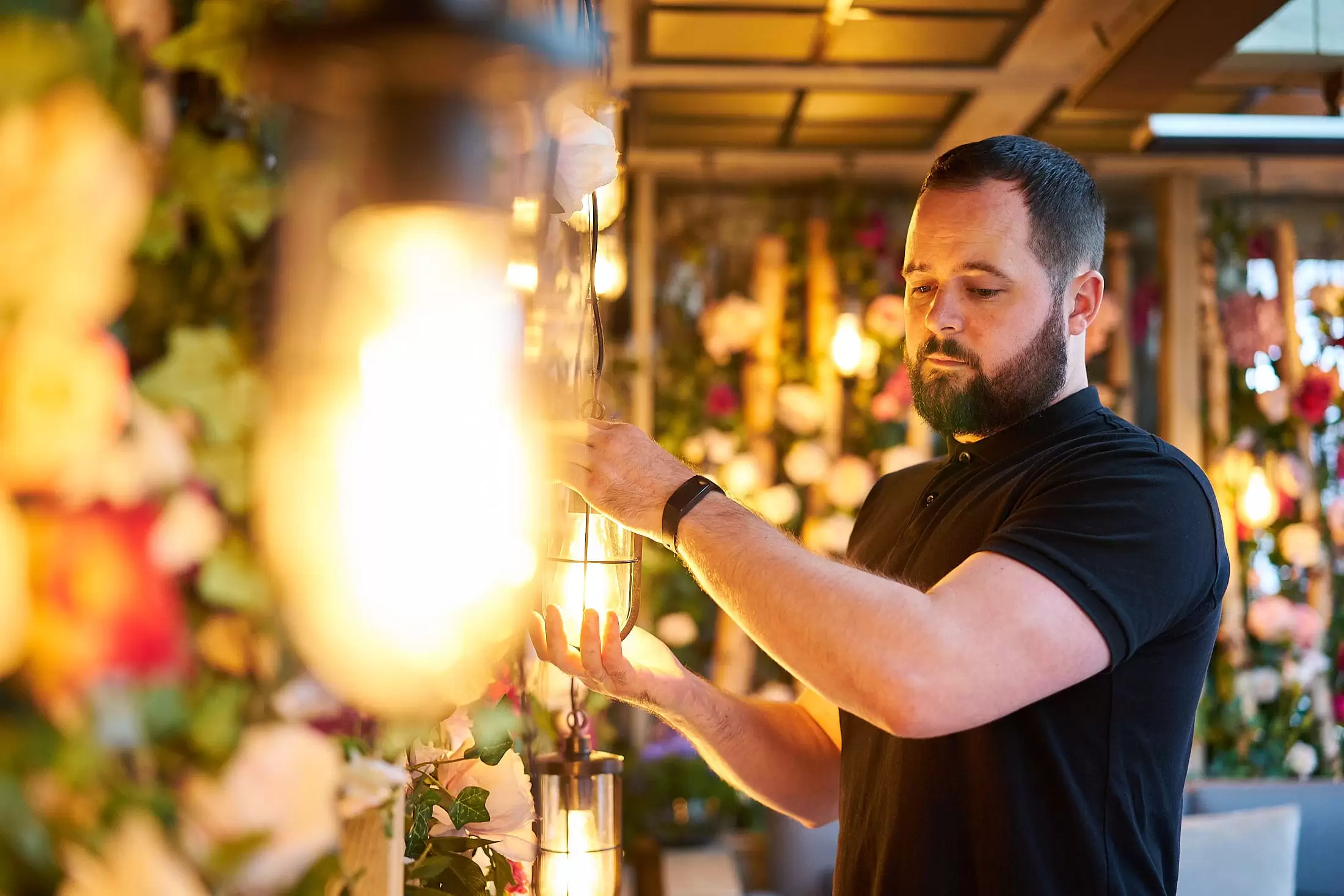 A Hari engineer fixing a light on the Garden Terrace
