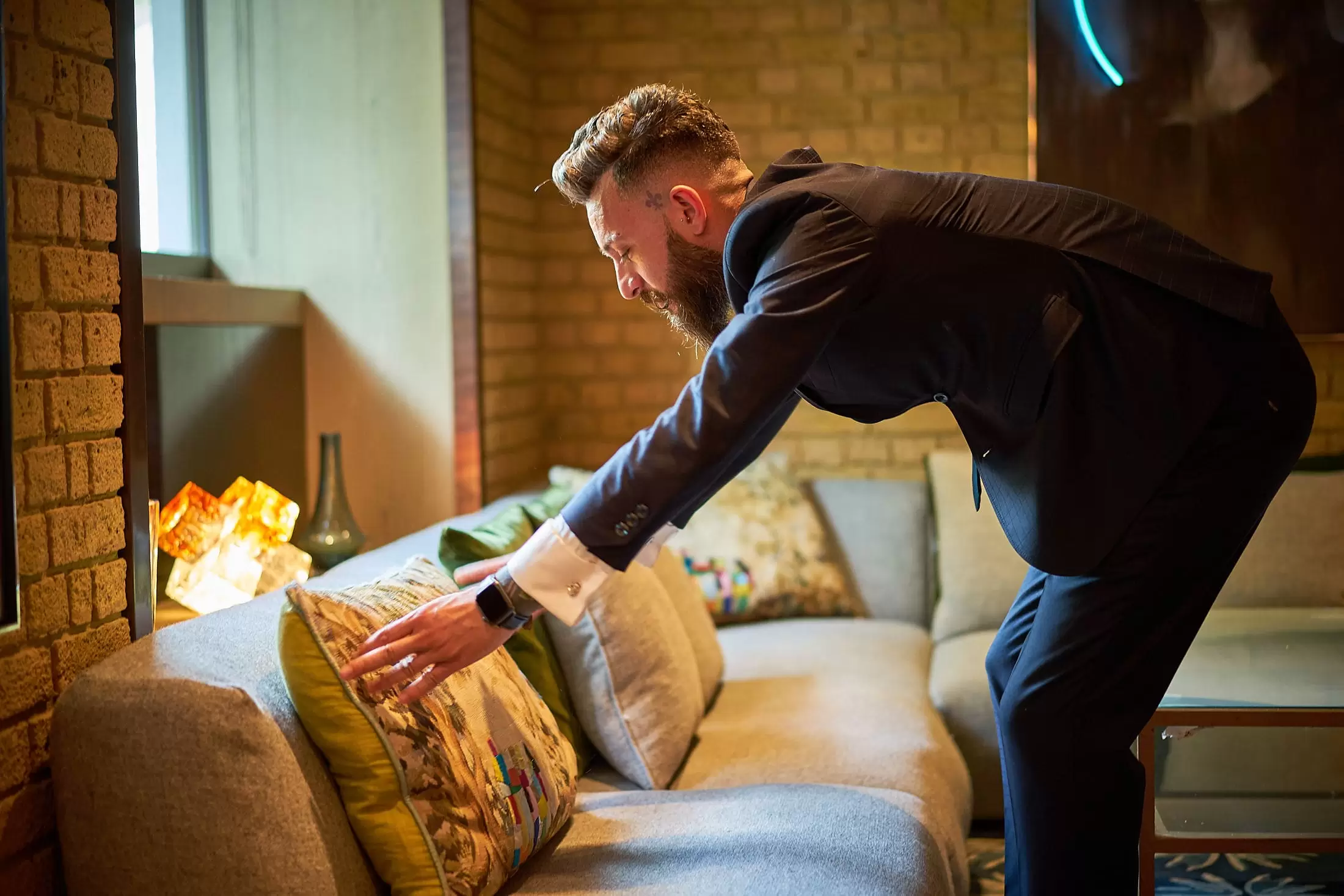 A Hari employee perfecting the cushions in The Hari Bar