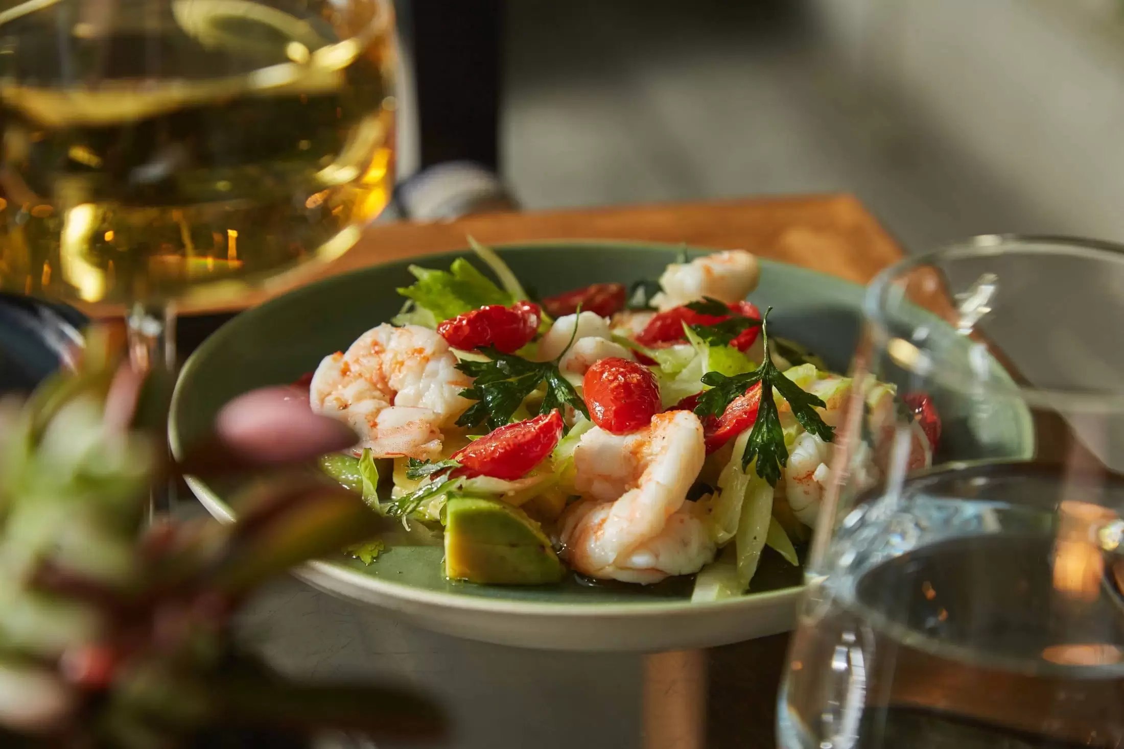 Prawn Salad being served alongside a glass of whitew wine on The Garden Terrace